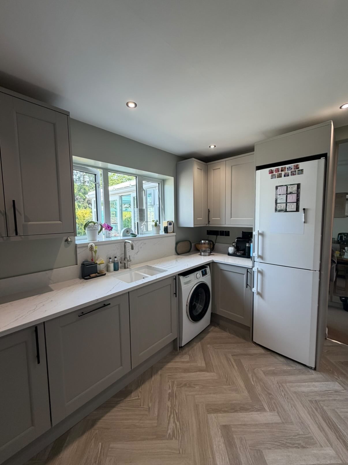 Grey shaker kitchen with marble effect worktops and integrated appliances