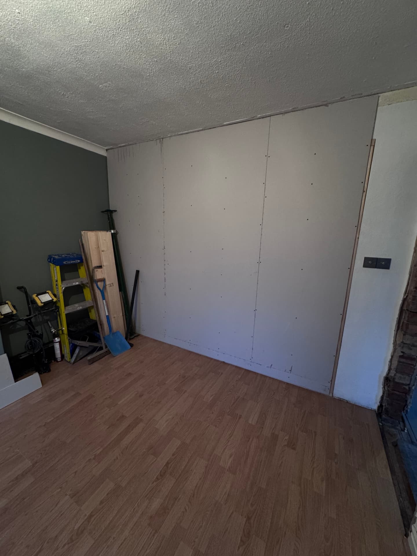 New stud wall boarded to separate the lounge