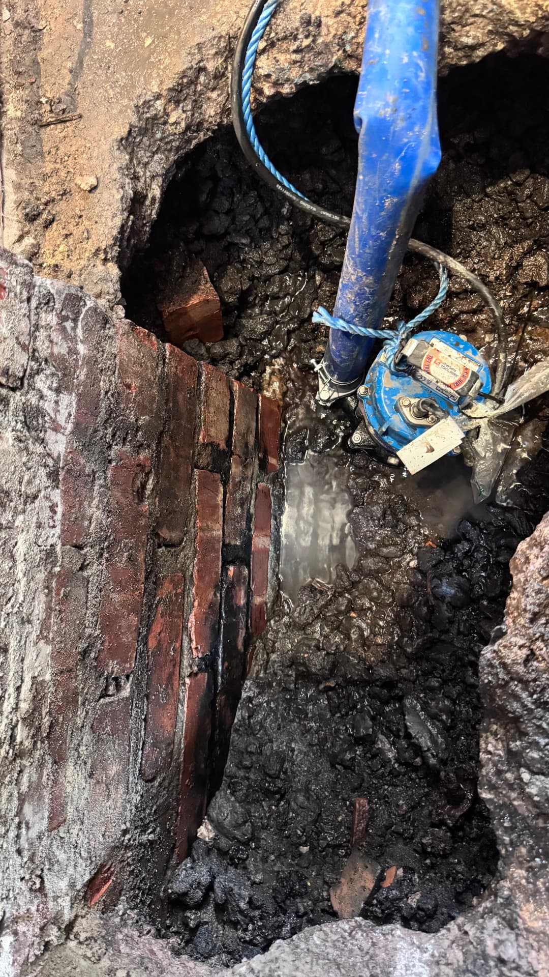 Submersible pump sumping water out of the excavation before pouring the footing