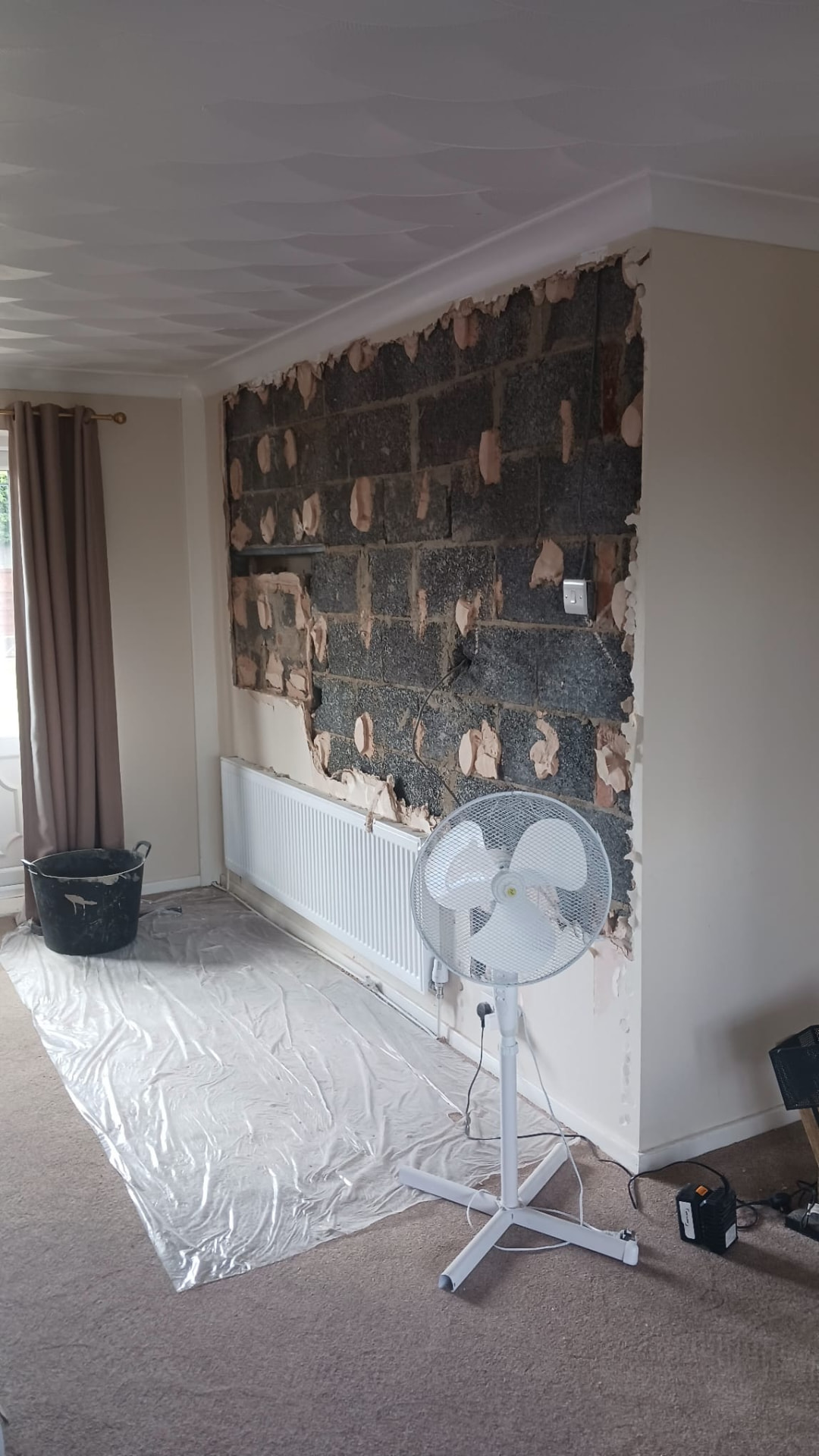 Living room wall hacked back to blockwork ready for replastering