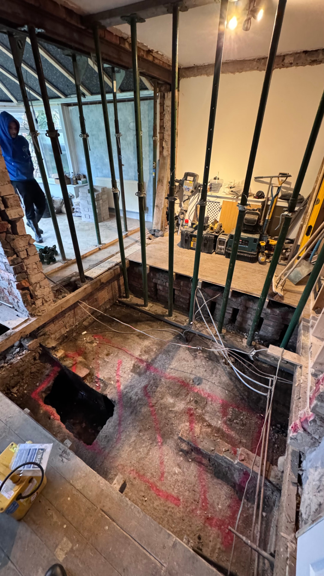 Excavation marked out below floor level to locate the foundations