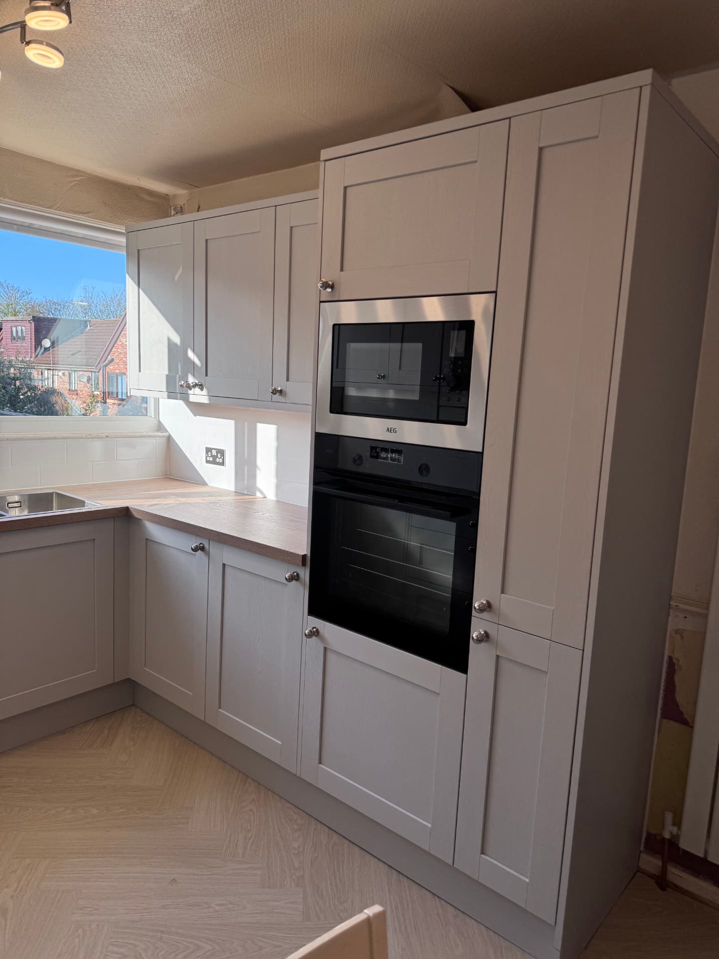 Grey kitchen with built-in double oven and microwave tower unit