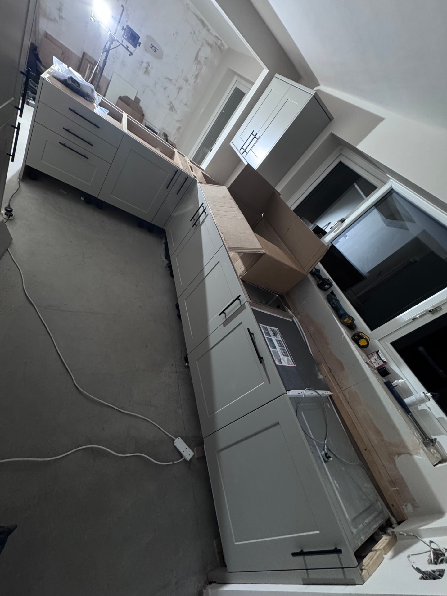 Run of grey shaker units and larder installed during the kitchen fit