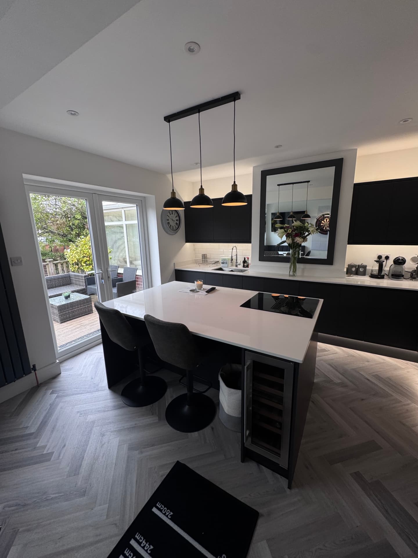 Finished kitchen with quartz island and herringbone flooring