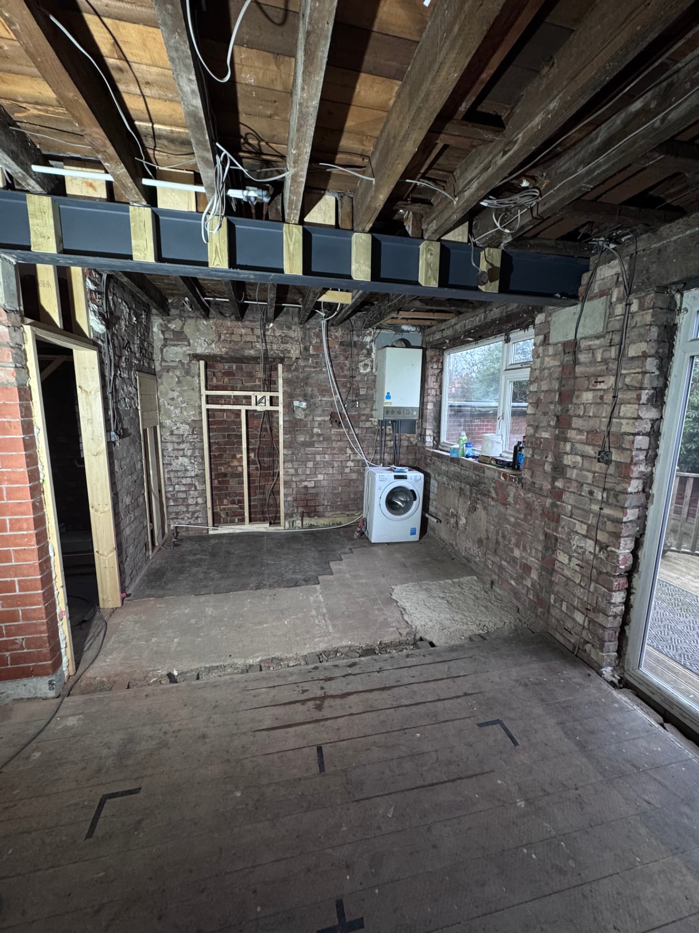 Kitchen stripped to brick with steel beam and new openings framed