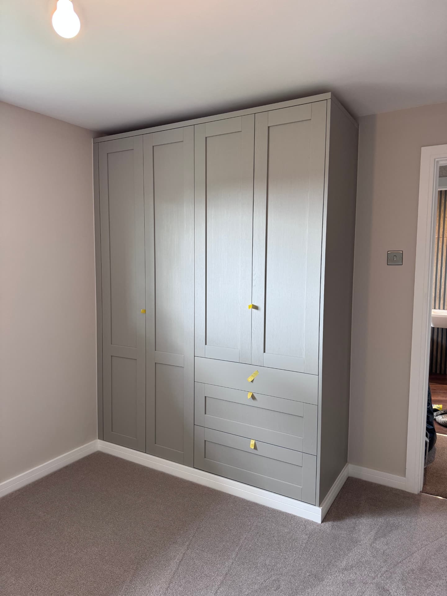 Bespoke shaker wardrobes fitted in a bedroom, awaiting handles