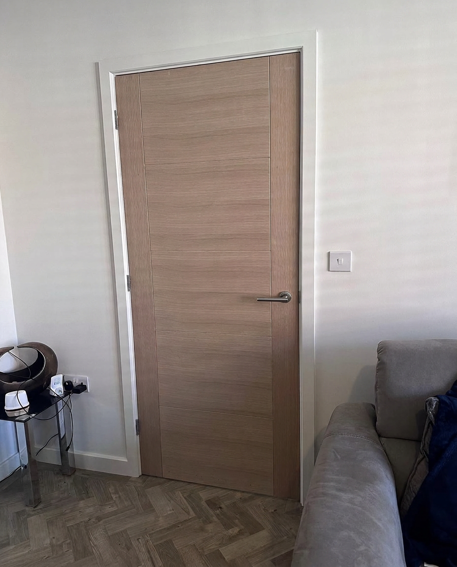 Oak internal door with chrome handle in a living room