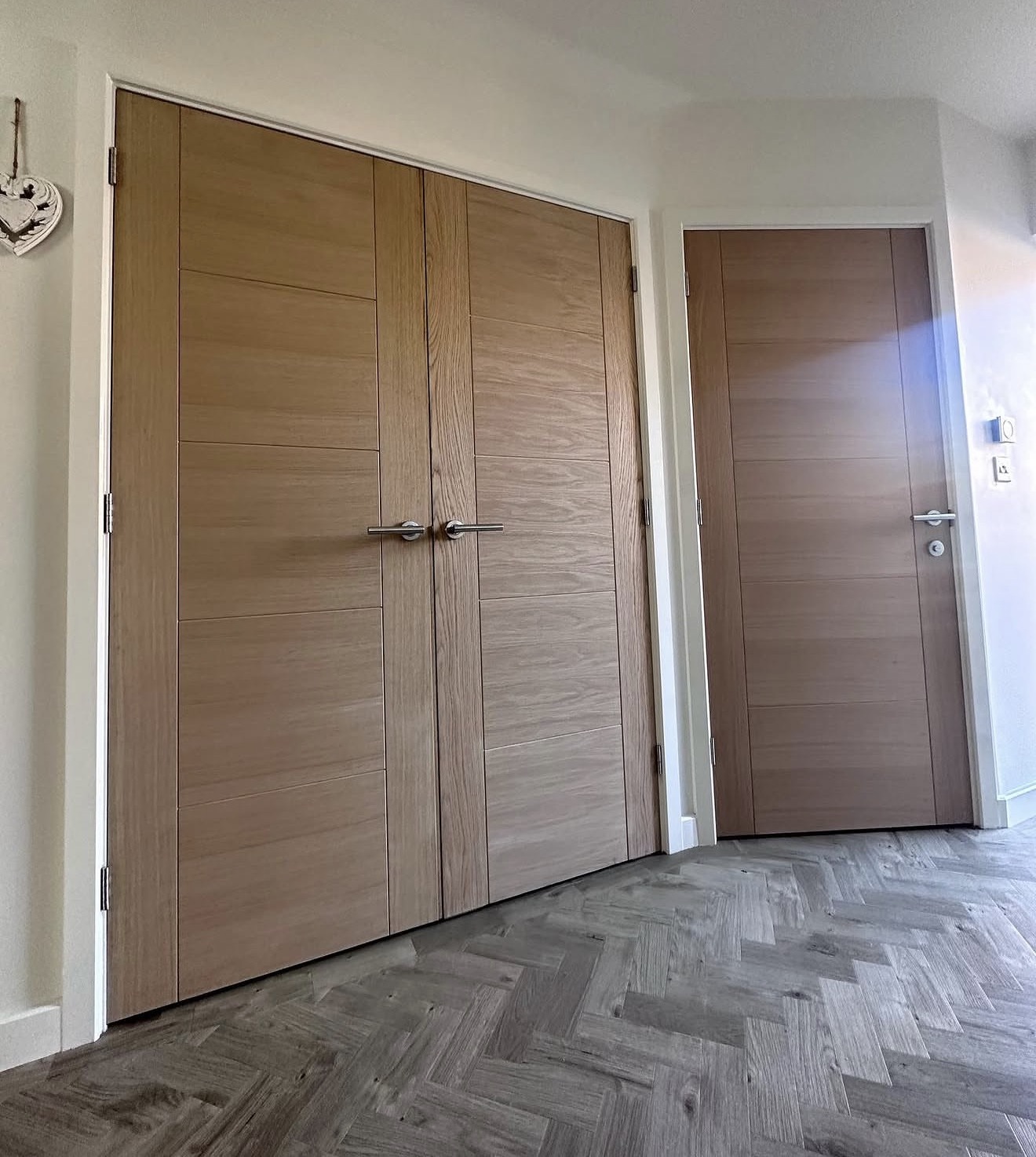 Oak double doors and single door fitted in a bedroom