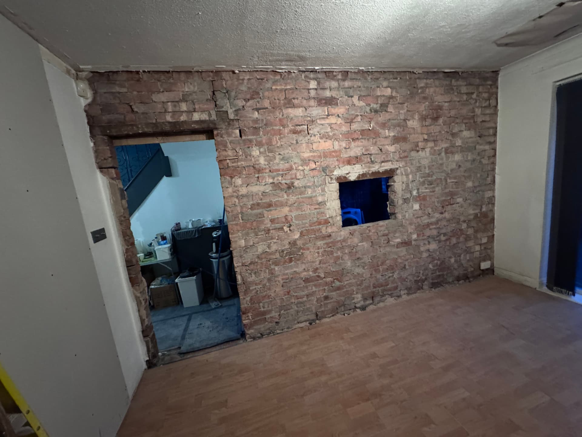 Dining room wall stripped back to brick with new openings formed