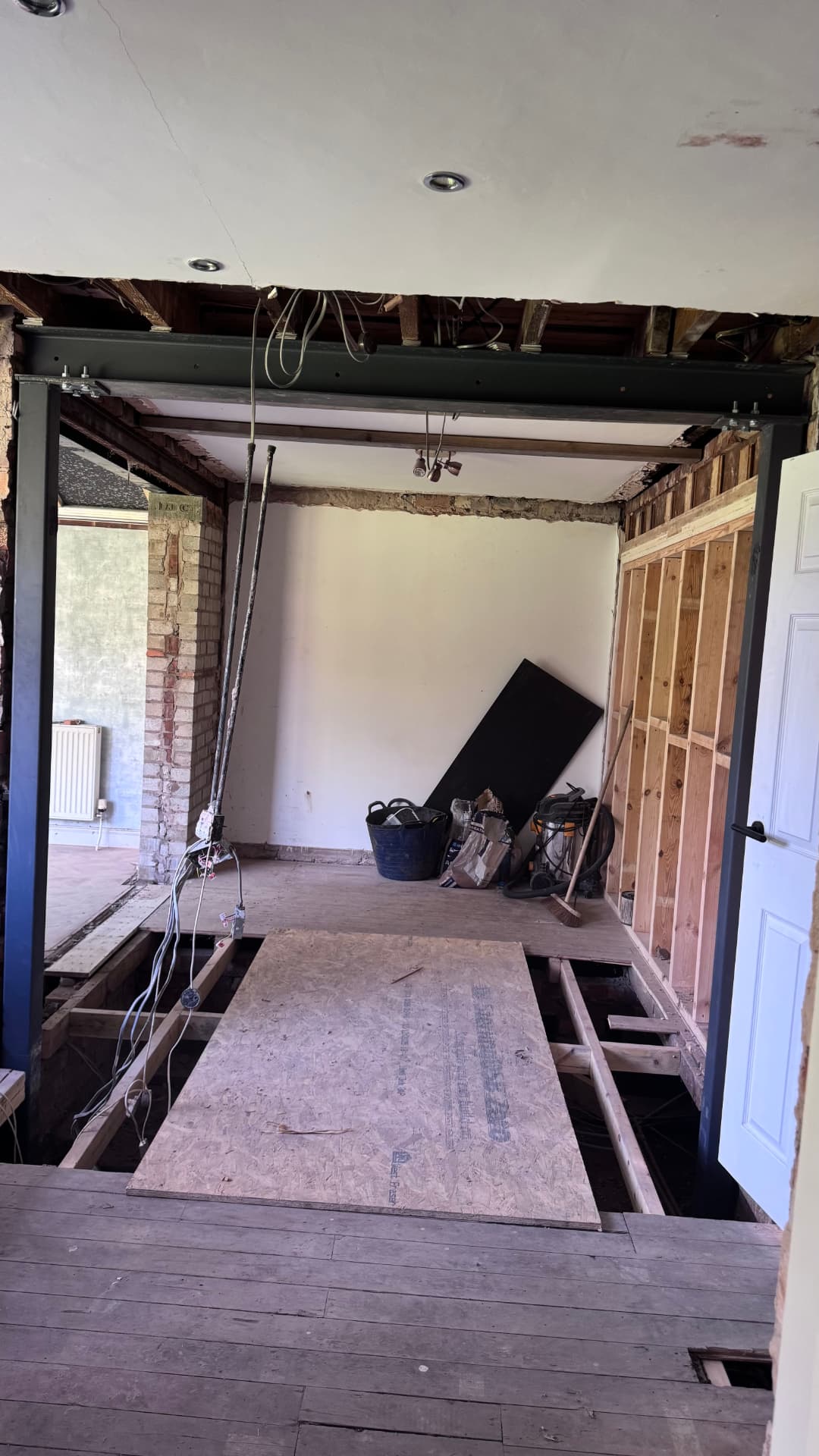 Steel frame installed with new stud wall and floor opened up