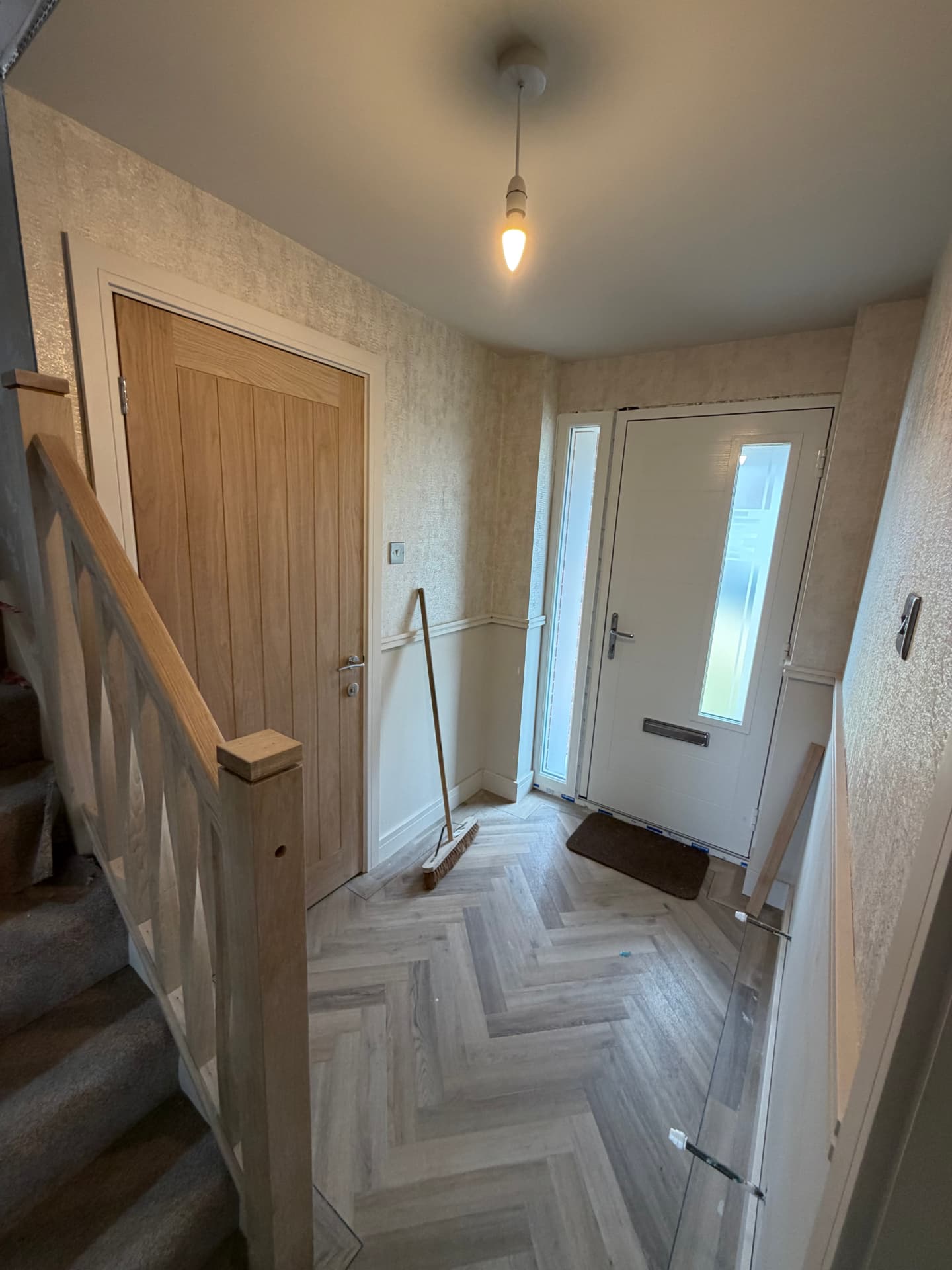 Finished hallway with oak doors, new staircase and herringbone flooring