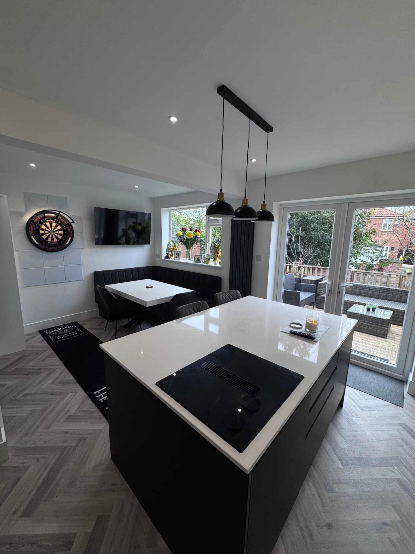 Open kitchen-diner with bespoke corner seating and French doors