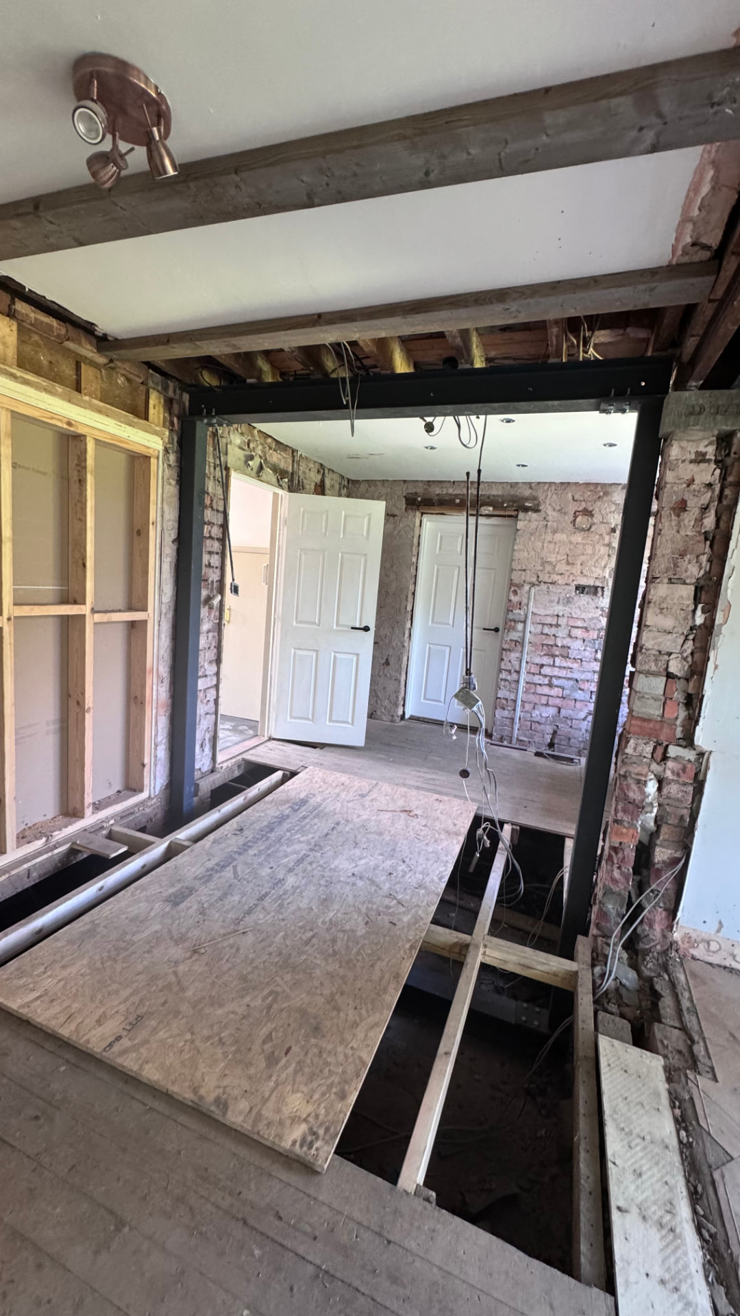 Steel goalpost frame in place with walls stripped back to brick