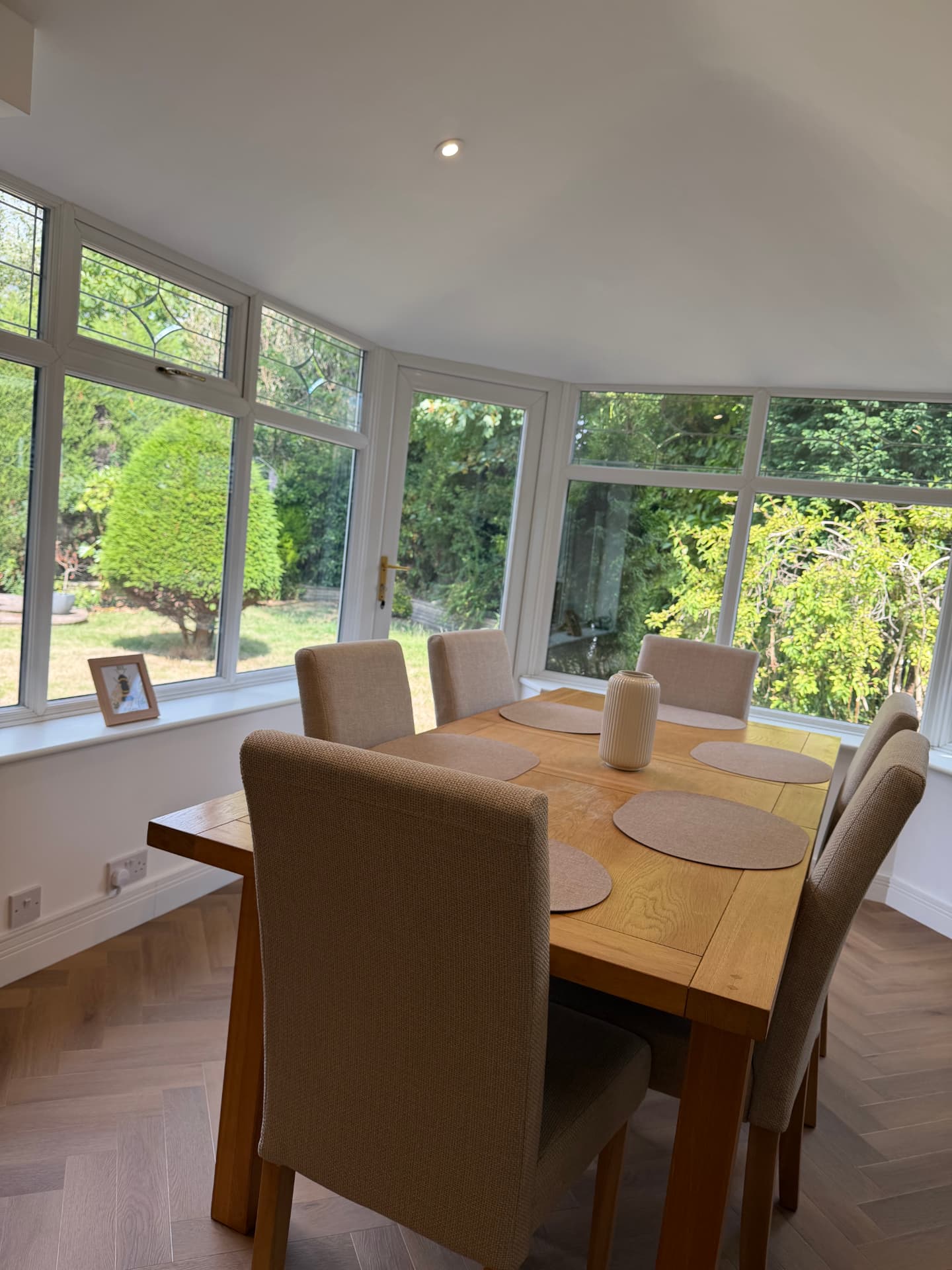 Finished dining area with bay windows and herringbone flooring