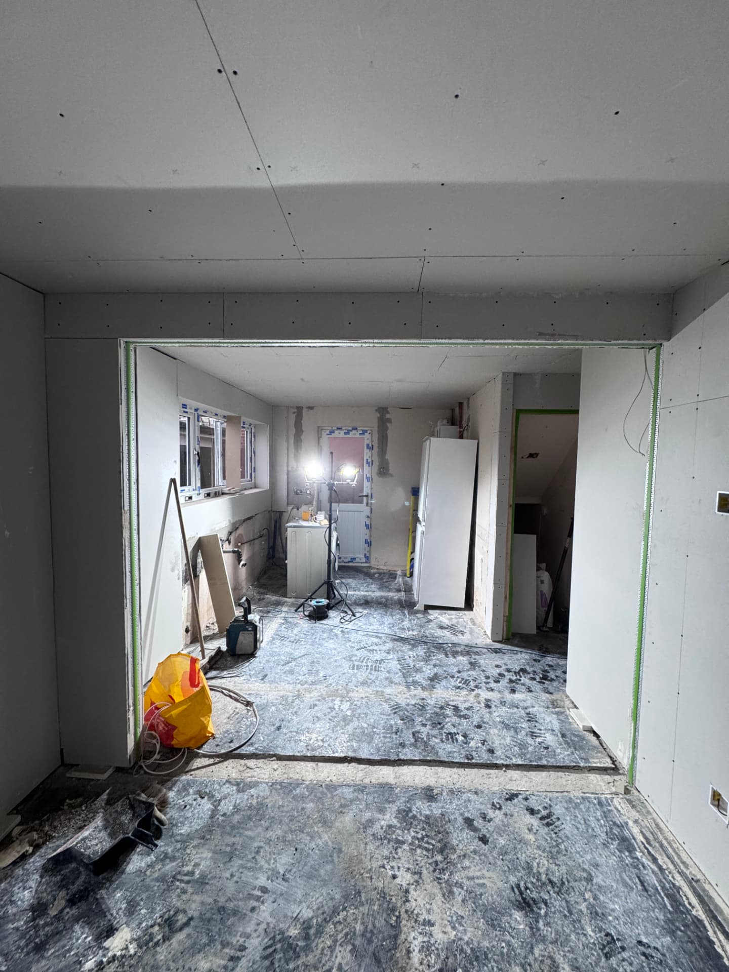 Wide opening formed between the living space and kitchen, fully boarded