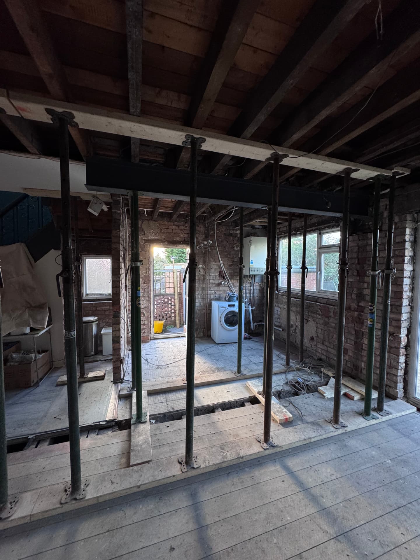 Supporting wall removed with acrow props and steel beam in place