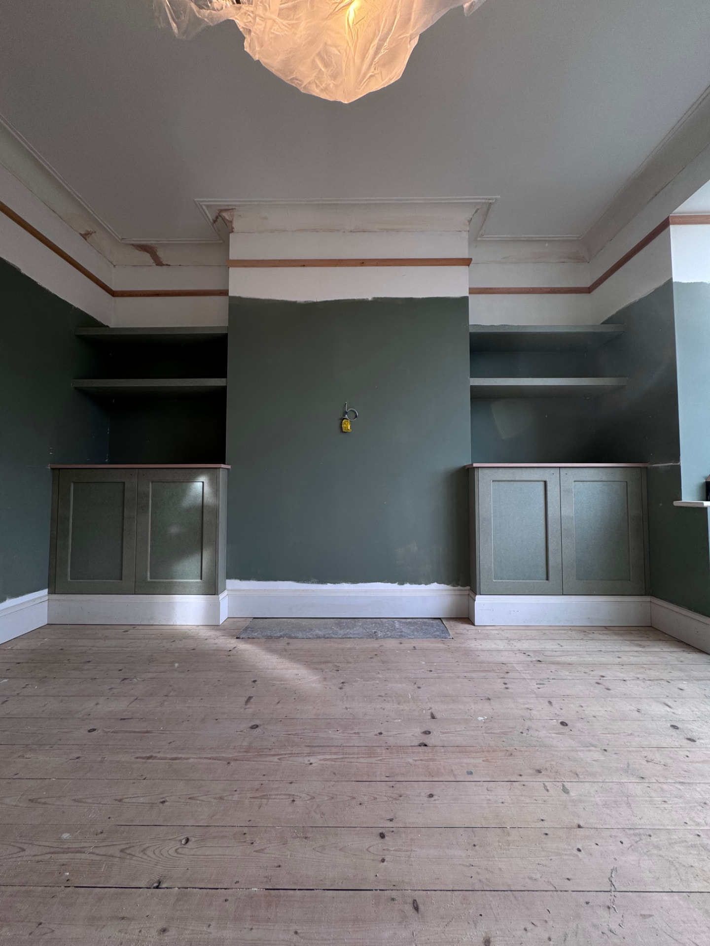 Matching fitted alcove cupboards and shelving in a period living room